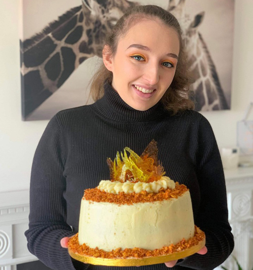 a female student holding a cake