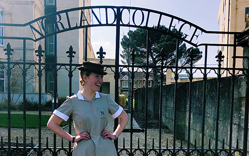 a female in front of Norland gates