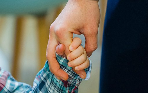 child holding an adults hand