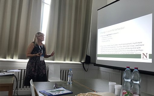 lady presenting in front of a large screen