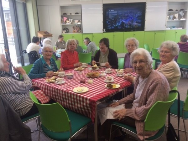 image of elderly people round a table