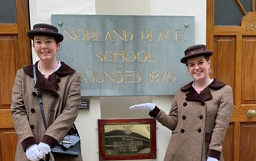 two female Norland students in their formal uniform