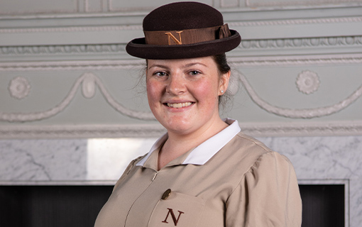 a female student in her formal uniform smiling