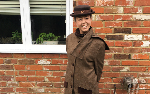 A female Norland Nanny in her Norland uniform smiling