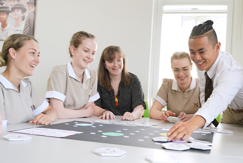 students sat around a table participating in an activity