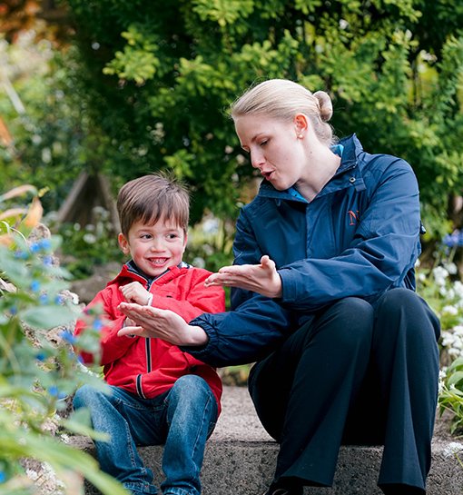 boy and Norland nanny in a garden