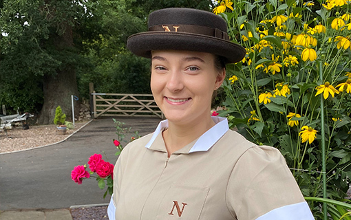 a female student in her formal uniform smiling