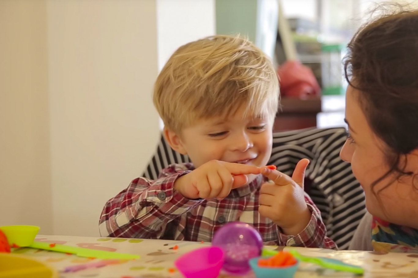 child and female nanny doing arts and crafts