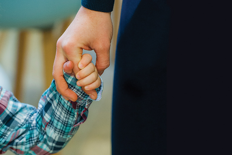 child holding an adults hand