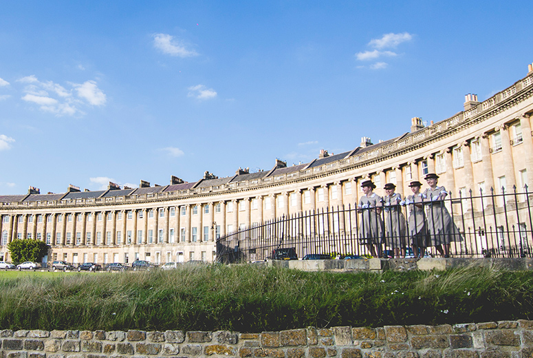 four female Norland nannies standing in front of georgian townhouses in Bath, UK