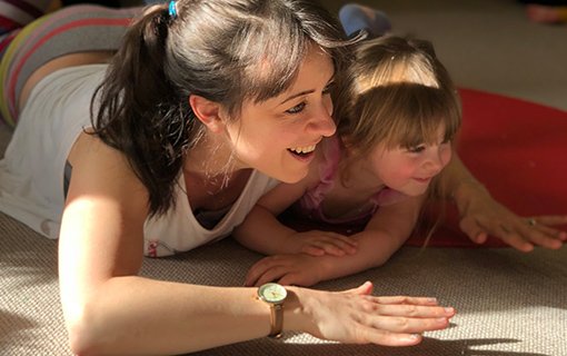 image of a lady and child lying on the floor playing